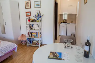 a living room with a table with a bottle of wine at Apartments Heaven in Cetinje