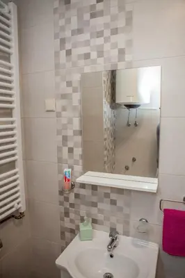 a bathroom with a sink and a mirror at Apartments Heaven in Cetinje