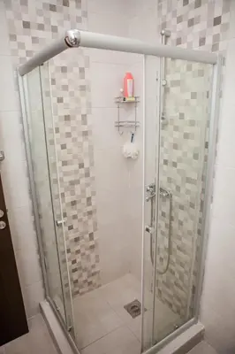 a shower with a glass door in a bathroom at Apartments Heaven in Cetinje
