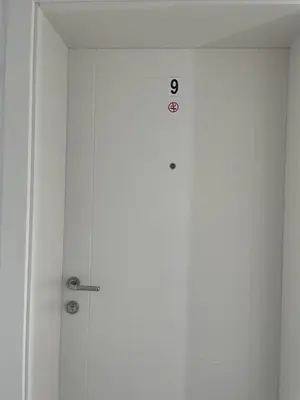 a door with a clock on top of it at Kristina Apartments in Tivat
