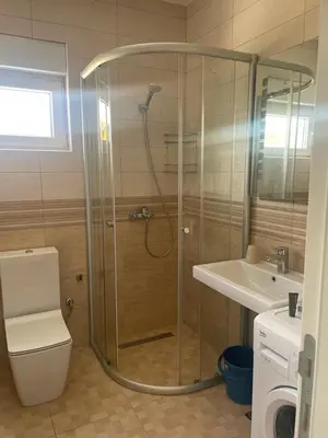 a shower in a bathroom with a toilet and a sink at Kristina Apartments in Tivat