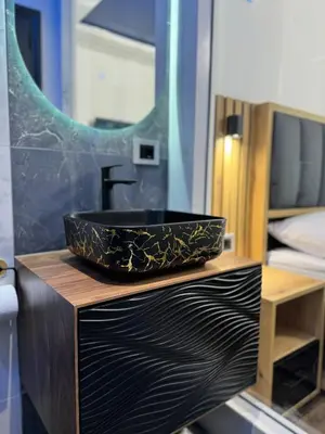 a bathroom with a black sink and a mirror at Blue Star Apartments in Ulcinj