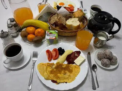 a table topped with a plate of breakfast food at Blue Star Apartments in Ulcinj