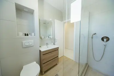 a bathroom with a toilet and a sink and a shower at Apartment Luxury Explorer in Podgorica