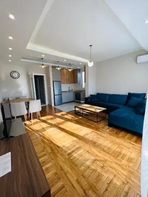 a living room with a blue couch and a table at Apartment Luxury Explorer in Podgorica