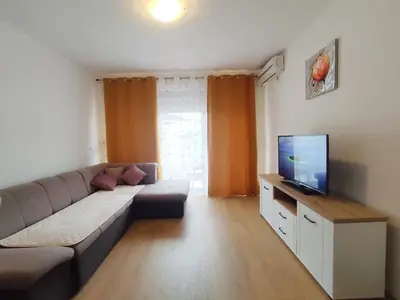 a living room with a couch and a flat screen tv at Adrialux2 in Budva