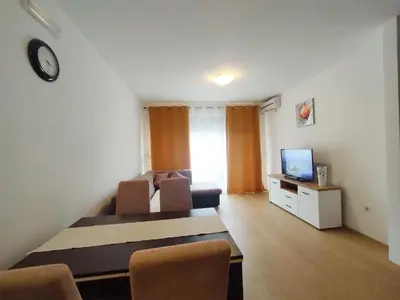 a living room with a couch and a tv at Adrialux2 in Budva