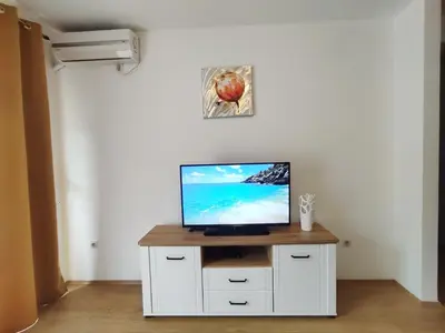 a television on a white cabinet in a room at Adrialux2 in Budva