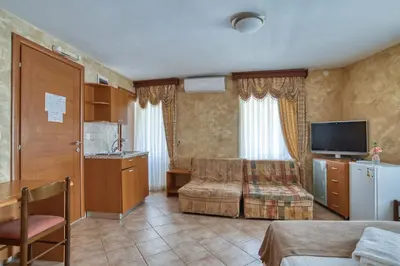 a hotel room with a kitchen and a living room at Hotel Rendez Vous in Kotor
