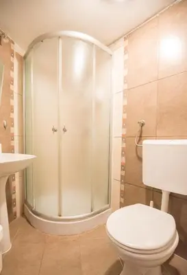 a bathroom with a toilet and a shower at Hotel Rendez Vous in Kotor