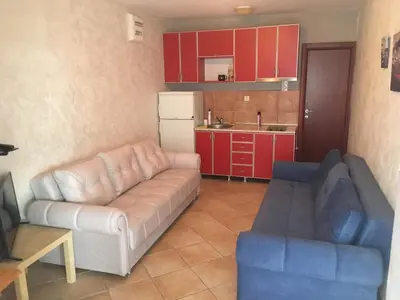 a living room with a couch and a kitchen at Impuls 2 in Budva