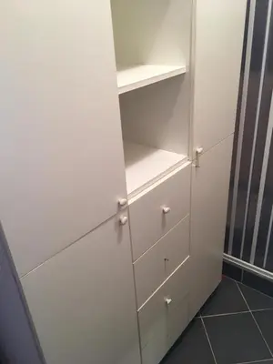 a white closet with white drawers and shelves at Impuls 2 in Budva