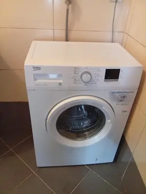 a white washing machine sitting in a bathroom at Impuls 2 in Budva