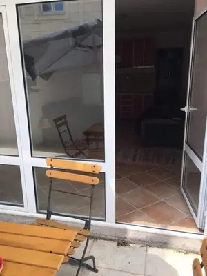 a bench sitting in front of a sliding glass door at Impuls 2 in Budva