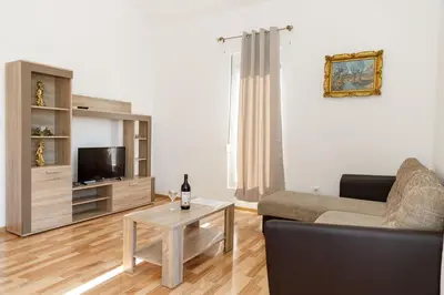 a living room with a couch and a table at Vila Nikezić in Sutomore