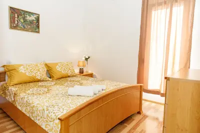 a bedroom with a bed with two towels on it at Vila Nikezić in Sutomore