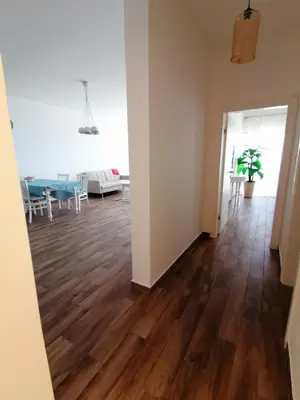 an empty living room with wood floors and a dining room at Your Home Montenegro in Dobra Voda