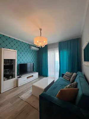 a living room with a couch and a television at Your Home Montenegro in Dobra Voda