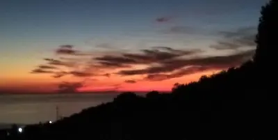 a sunset in the sky over a hill at Your Home Montenegro in Dobra Voda