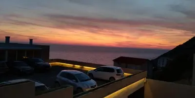 two cars parked on a balcony with a view of the ocean at Your Home Montenegro in Dobra Voda