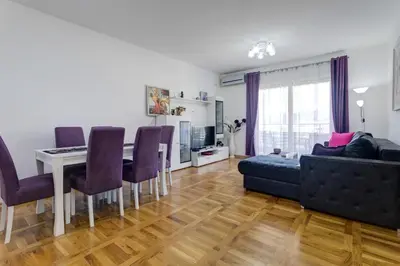 a living room with a couch and a table at Belveder Apartments in Budva