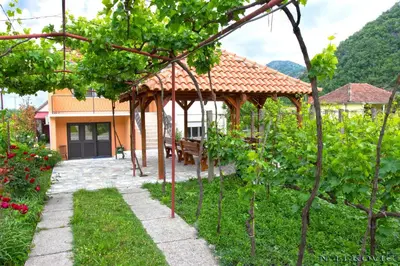 a gazebo in the garden of a house at Guesthouse Bato in Virpazar
