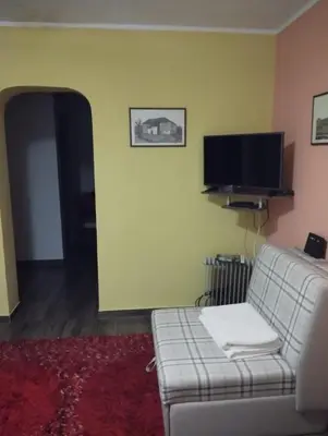 a living room with a couch and a flat screen tv at Guesthouse Bato in Virpazar