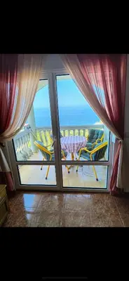 a room with a view of the ocean from a balcony at Majero Apartments in Utjeha