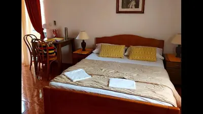 a bedroom with a bed with two towels on it at Majero Apartments in Utjeha