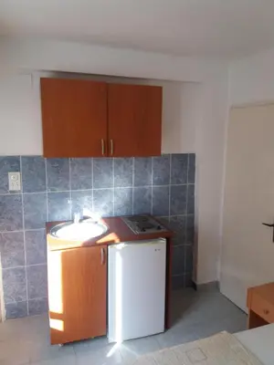 a kitchen with a sink and a white refrigerator at Apartments MM Budva in Budva