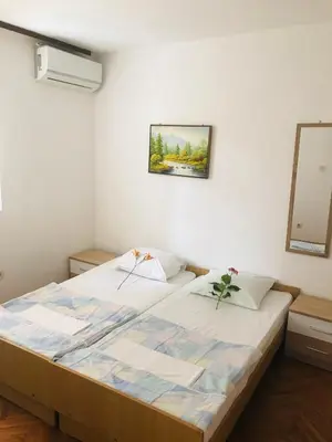 a bedroom with a large bed in a room at Apartments MM Budva in Budva