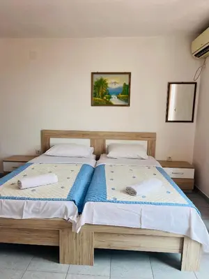 a bedroom with two beds with towels on them at Apartments MM Budva in Budva