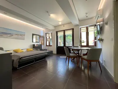 a bedroom with a bed and a table and chairs at Kotor Center W in Kotor