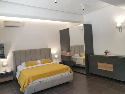 a bedroom with a bed with a yellow blanket at Kotor Center W in Kotor