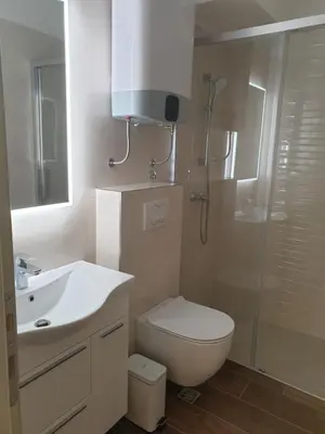 a bathroom with a shower and a toilet and a sink at Kotor Center W in Kotor