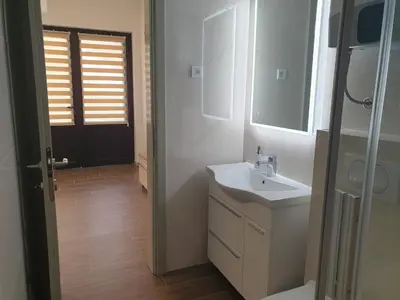 a white bathroom with a sink and a mirror at Kotor Center W in Kotor