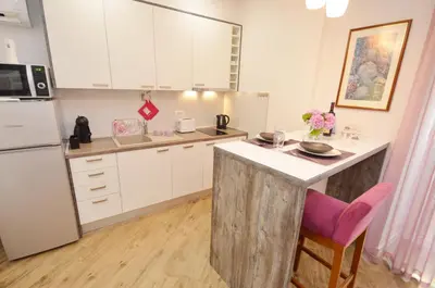 a kitchen with white cabinets and a counter top at Kotor Center W in Kotor