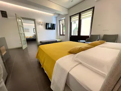 a hotel room with two beds and a television at Kotor Center W in Kotor