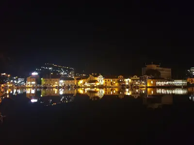 a city lit up at night with a body of water at Kotor Center W in Kotor