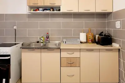 a small kitchen with a sink and a stove at Green Harmony in Tivat