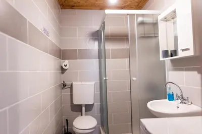 a bathroom with a toilet and a sink at Green Harmony in Tivat