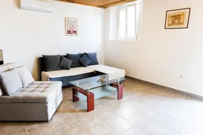 a living room with a couch and a coffee table at Green Harmony in Tivat