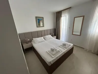 a bedroom with a bed with two towels on it at Apartmani Alexandra in Budva