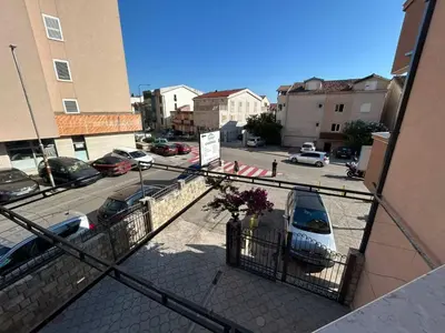 a balcony with a van parked in a parking lot at Apartmani Alexandra in Budva
