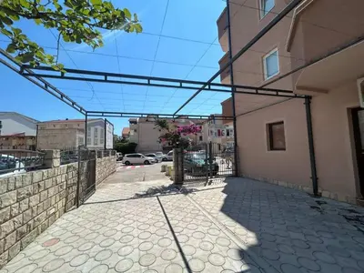 an empty sidewalk in front of a building at Apartmani Alexandra in Budva