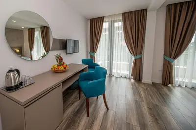 a room with a vanity with blue chairs and a mirror at B&B Amfora in Petrovac na Moru