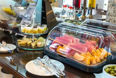 a buffet with a tray of different types of food at B&B Amfora in Petrovac na Moru