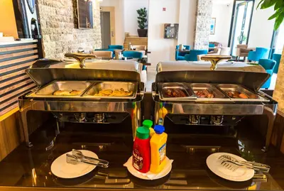 two trays of food on a counter in a restaurant at B&B Amfora in Petrovac na Moru