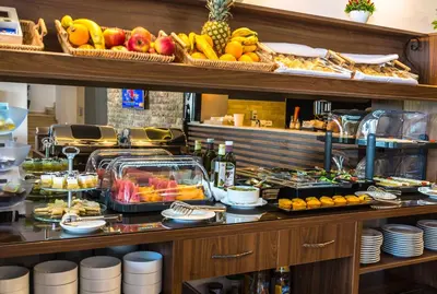 a buffet with fruits and food on a table at B&B Amfora in Petrovac na Moru