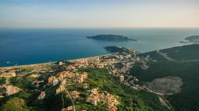 an aerial view of a town on a hill next to the ocean at 